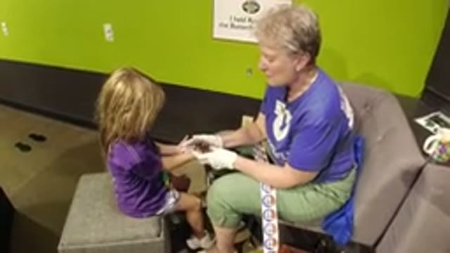 BROOMFIELD COLORADO-2019: An Older Woman Shows a Spider to a Little Girl