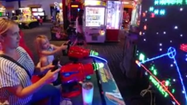 BROOMFIELD COLORADO-2019: Mother And Daughter Play An Arcade War Game In Outer Space