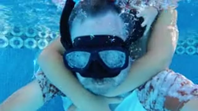 LOS CABOS MEXICO-2019: A Man And A Woman Are Swimming In A Swimming Pool Wearing Swimsuits And Goggles