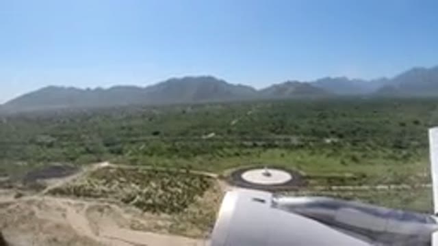 LOS CABOS MEXICO-2019: Airplane Lifting Off Over Beautiful Green Fields