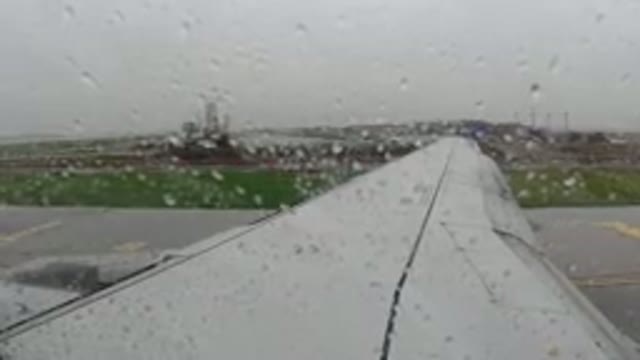 LOS CABOS MEXICO-2019: View Out Airplane Window Of Buildings In Distance And Rain