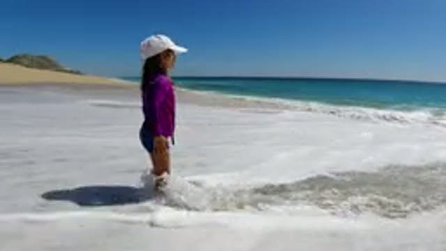 LOS CABOS MEXICO-2019: A Person Is Waiting For The Wave To Hit Her From The
