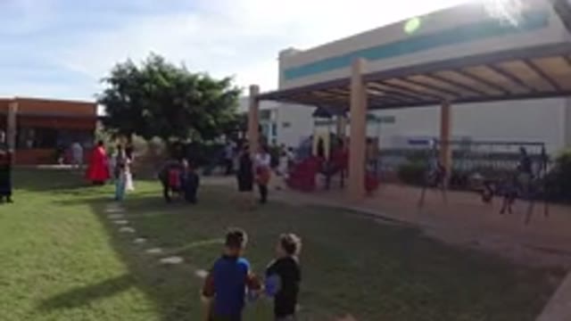 LOS CABOS MEXICO-2019: People Gathered In A Grassy Courtyard With Stone Walkways