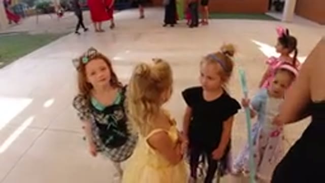LOS CABOS MEXICO-2019: Small Children in Dresses Having a Conversation in Group at a Party