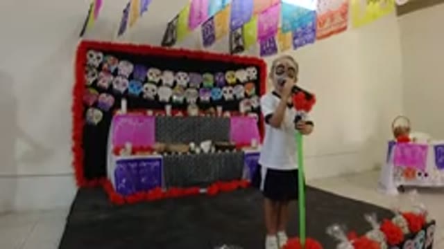 LOS CABOS MEXICO-2019: Little Girl Singing Indoor With Painted Mask