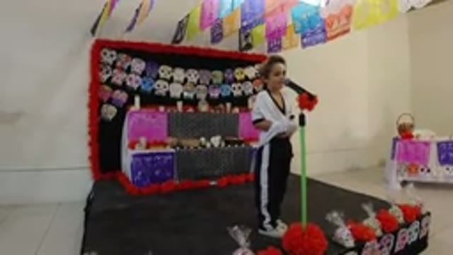 LOS CABOS MEXICO-2019: Girl Speaking on Stage with Colorful Paper Decorations