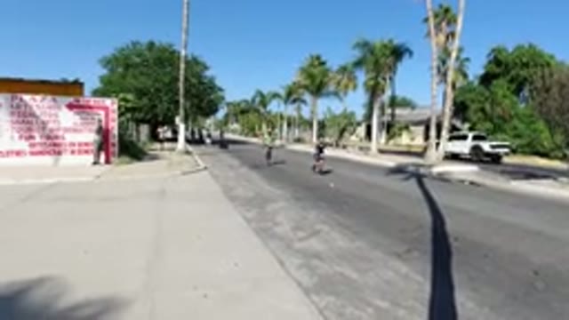 LOS CABOS MEXICO-2019: Man Jogging On Road While Another Man Walks Behind Him