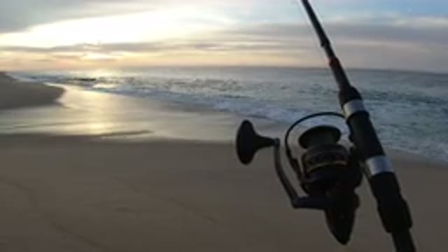 LOS CABOS MEXICO-2019: Front Shot Of A Fishing Rod On The Beach With A Wavy Sea