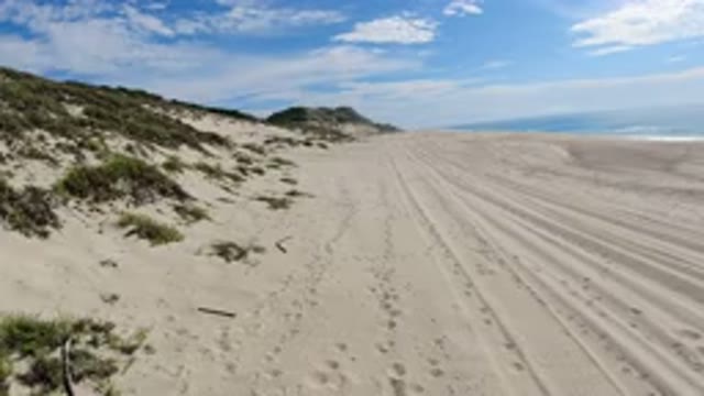 LOS CABOS MEXICO-2019: Sandy Desert Beach on a Partially Cloudy Day with Calm Sea