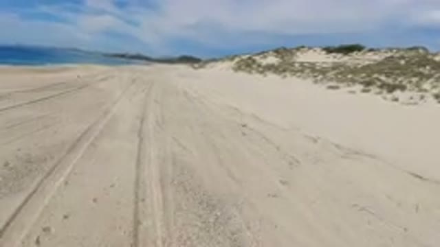 LOS CABOS MEXICO-2019: Jeep Travel Near The Beach On Rough Road With Water And Sand