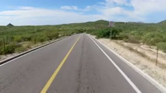LOS CABOS MEXICO-2019: Speeding Wrangler On A Motionless Road Surrounded By Vegetation