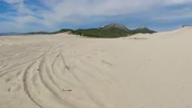 LOS CABOS MEXICO-2019: Video Of A Bike Riding Slowly On The Sandy Coast Near
