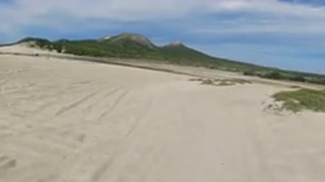 LOS CABOS MEXICO-2019: A Vehicle Drives Down A Sandy Road In A Wilderness Area
