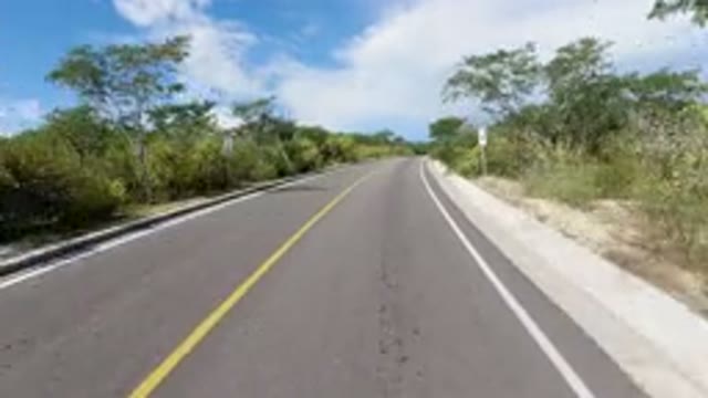 LOS CABOS MEXICO-2019: Driving Down Deserted Road On Sunny Day With Blue Sky And Puffy Clouds