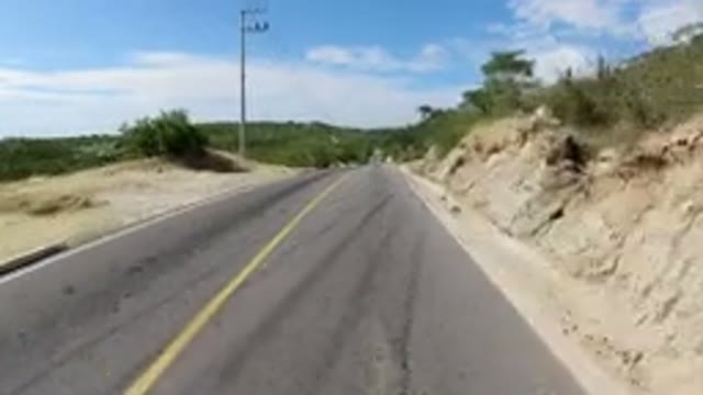 LOS CABOS MEXICO-2019: Driving Over The Tip Of A Small Hill On A Paved Road