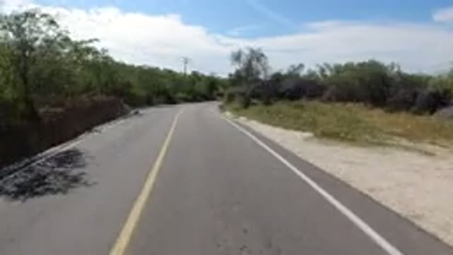 LOS CABOS MEXICO-2019: A Wrangler Going Up A Winding Street Passes By A Pickup