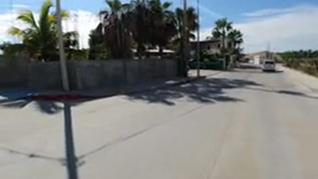 LOS CABOS MEXICO-2019: Rolling Down The Street Passing A Truck On A Dry Sunny Day