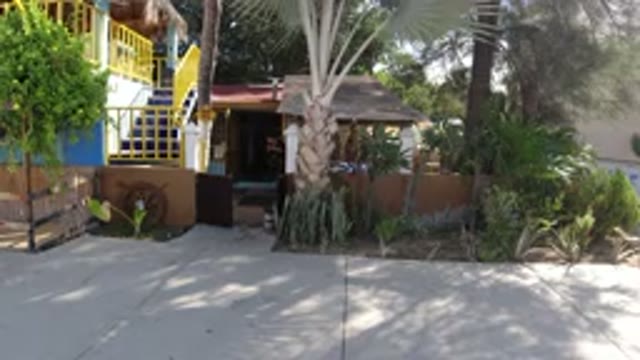 LOS CABOS MEXICO-2019: A Man Cleaning the Front of a House