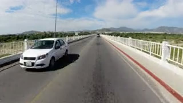 LOS CABOS MEXICO-2019: A White Vehicle Traveling on Highway with Traffic
