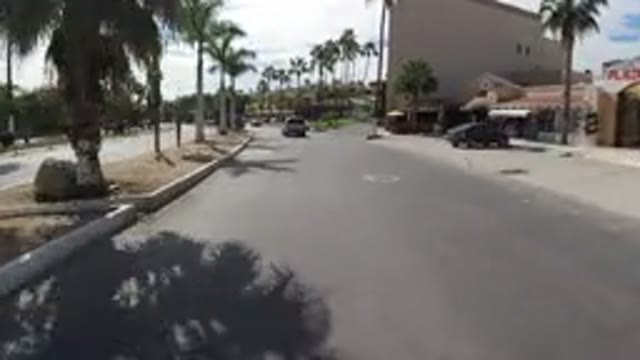 LOS CABOS MEXICO-2019: Driving Down A Sunny City Road Turning Right On A Street