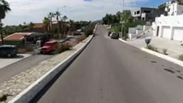 LOS CABOS MEXICO-2019: Woman Walking Down Street Through Neighborhood With Wrangler