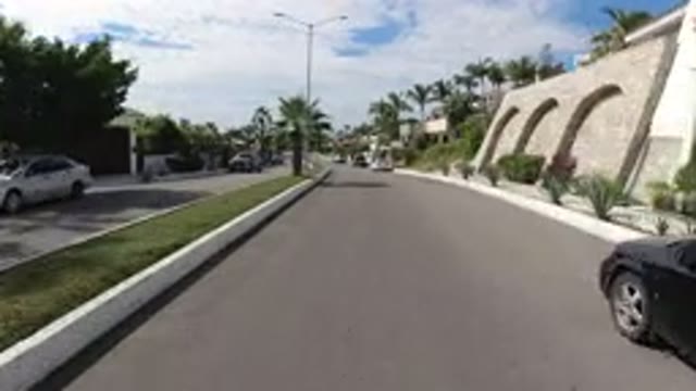 LOS CABOS MEXICO-2019: A View Of The Street With Wranglers Trees And Houses On A