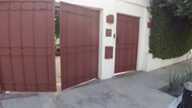 LOS CABOS MEXICO-2019: Large Red Automatic Garage Door Opens To Reveal Pretty Home