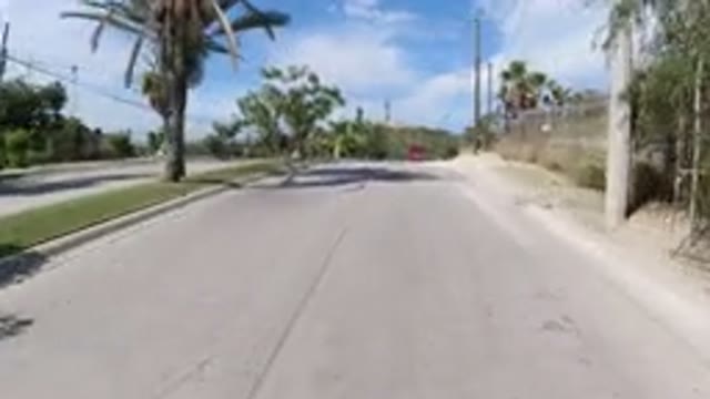 LOS CABOS MEXICO-2019: Driving Down The Road With Palm Trees Around And Mountains In Distance