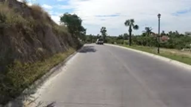 LOS CABOS MEXICO-2019: Vehicle Moves Down Divided Highway With Palm Trees on Sides