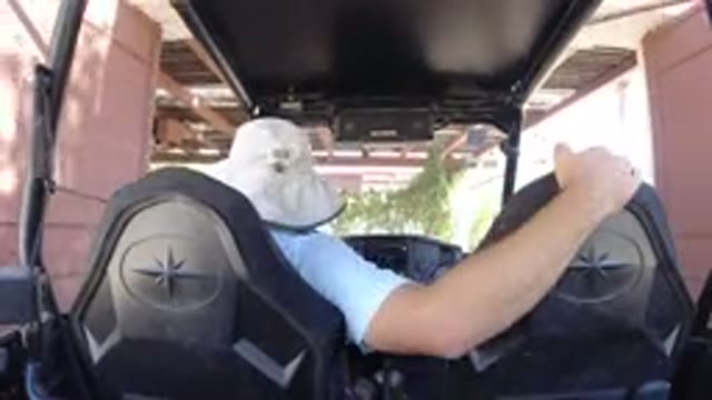 LOS CABOS MEXICO-2019: Man In Bucket Hat Drives Golf Cart In Reverse Through