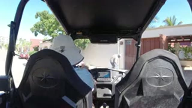 LOS CABOS MEXICO-2019: Person Driving Wrangler In Urban Area While Another Cleans Sidewalk