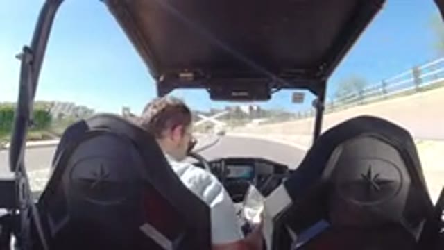 LOS CABOS MEXICO-2019: Mature Man Driving Golf Kart On Highway With Trees
