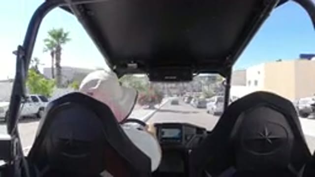 LOS CABOS MEXICO-2019: A Man In A Comfortable Hat Driving A Buggy Down The Street