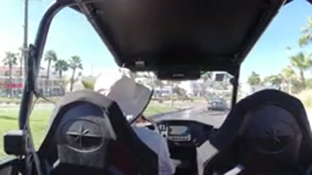 LOS CABOS MEXICO-2019: Vehicle Moves Down City Street Palm Trees On Either Side