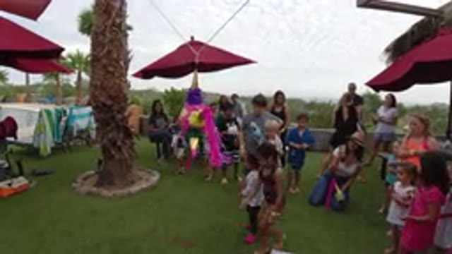 LOS CABOS MEXICO-2019: A Group of People Gathered in a Sunny Area with Umbrellas and Games