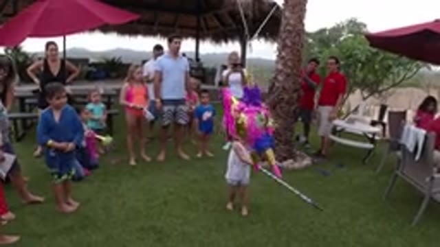 LOS CABOS MEXICO-2019: Little Girl Whacking Pinata at Family Party