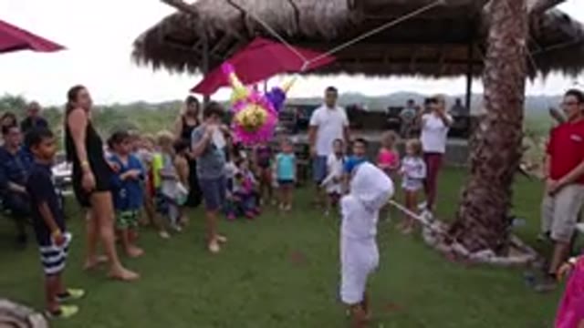 LOS CABOS MEXICO-2019: Little Child Hits Pinata With Stick In Front Of Others