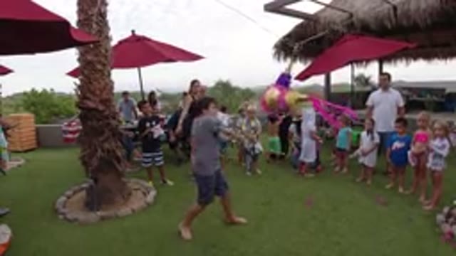 LOS CABOS MEXICO-2019: Family Celebrating A Birthday Party With A Pinata A Young Man