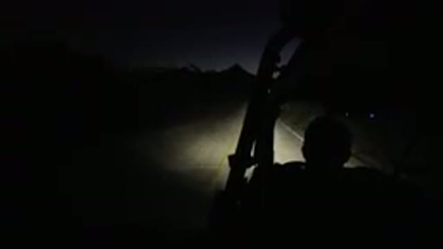 LOS CABOS MEXICO-2019: A Man In A Buggy Going Up A Dark Street Surrounded By