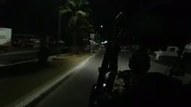 LOS CABOS MEXICO-2019: Vehicle Moves Down Divided City Street At Night Wranglers