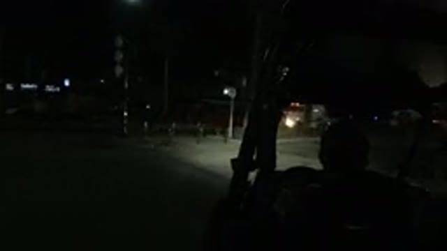 LOS CABOS MEXICO-2019: A Man Turns A Vehicle Onto A Road At Night And Drives