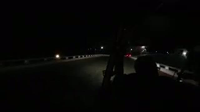 LOS CABOS MEXICO-2019: Person Driving Along Dark Bridge At Night With Bright Headlights