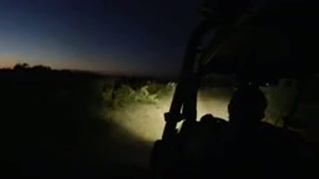 LOS CABOS MEXICO-2019: A Man In A Buggy Going Up A Dirt Road At Night Surrounded