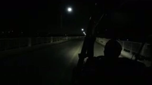 LOS CABOS MEXICO-2019: Vehicle Moves Down Two Lane Road At Night Guard Rails On