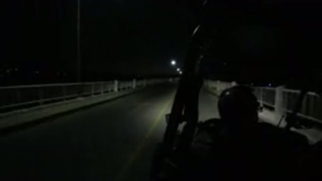 LOS CABOS MEXICO-2019: Two People Talking As They Drive A Jeep At Night Over A Bridge