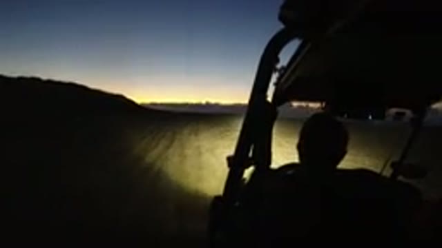 LOS CABOS MEXICO-2019: Shadowed Man Drives Vehicle Off-Road At Sunset Using The