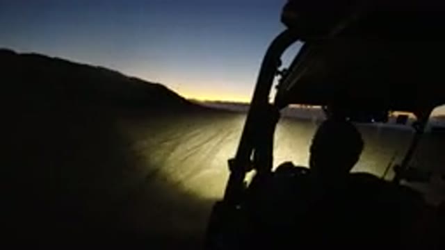 LOS CABOS MEXICO-2019: A Vehicle Driving Down A Dusty Road At Night With The