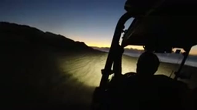 LOS CABOS MEXICO-2019: Vehicle Rides On Beach In Near Darkness With Sun On Horizon