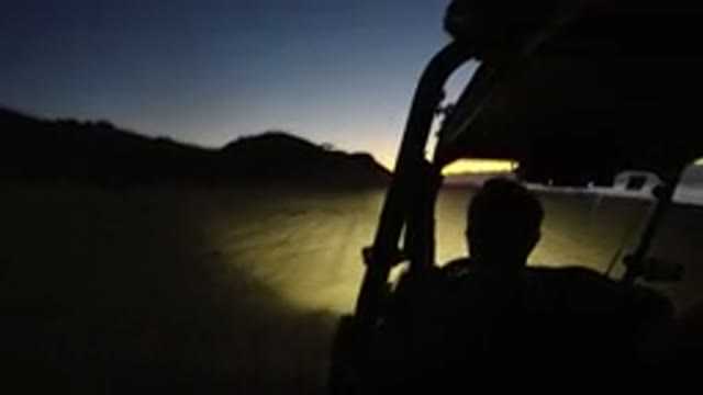 LOS CABOS MEXICO-2019: Man Driving Dune Buggy Through Desert Sand at Sunset