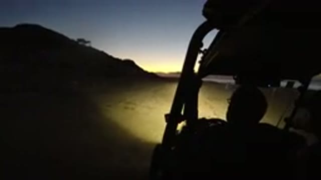 LOS CABOS MEXICO-2019: Two People Riding A Golf Cart At Night While Talking